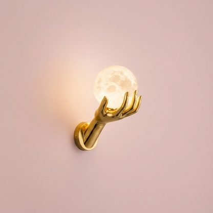Halo Wall Sconce, gold hand and moon globe, lit